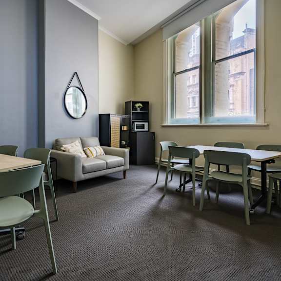 a dining room with tables and chairs and a couch