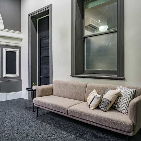 a living room with a couch and pillows on it