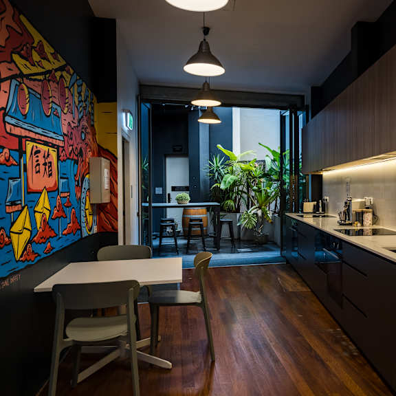 a kitchen with wooden cabinets and a table and chairs