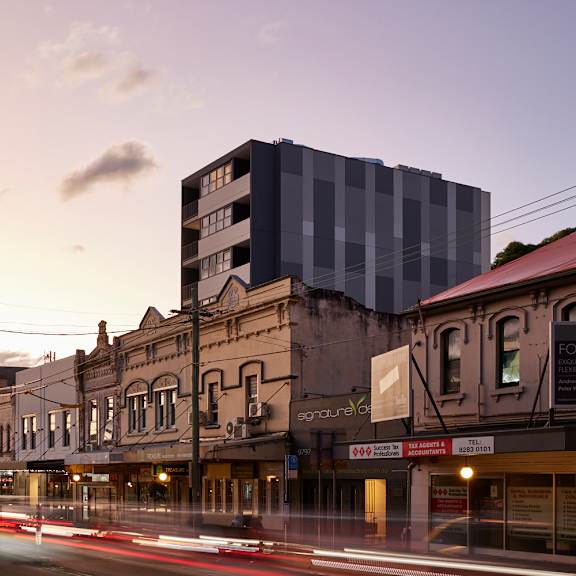 a city street with buildings and a tall building