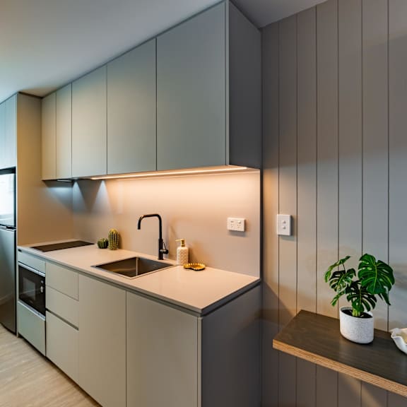 a kitchen with white cabinets and a sink