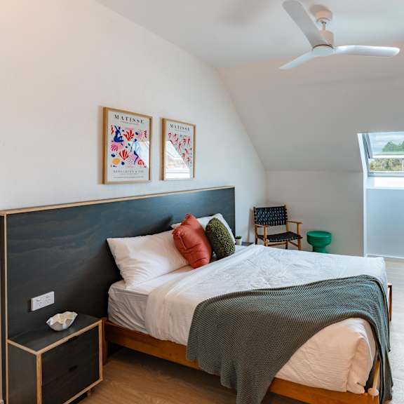 a bedroom with a large bed and a tv