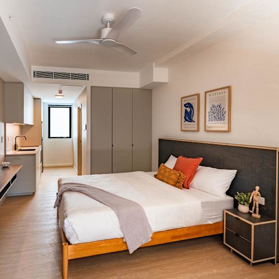 a bedroom with a large bed and a tv