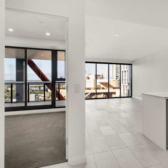 a modern kitchen with a large island and a view of the city.