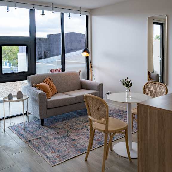 a living room with a couch and chairs and a table