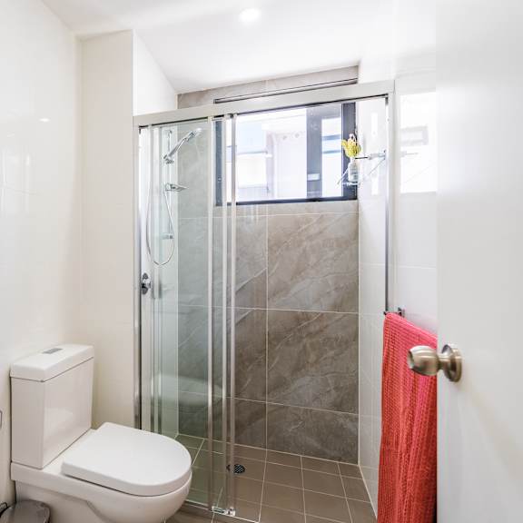 a bathroom with a shower toilet and sink