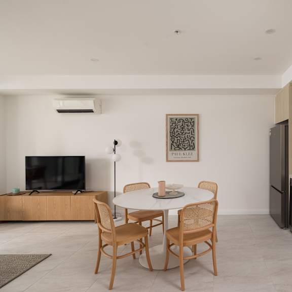 a modern kitchen with a dining table and chairs.