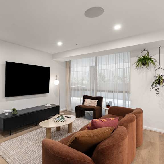 a living room with a flat screen tv mounted on the wall.