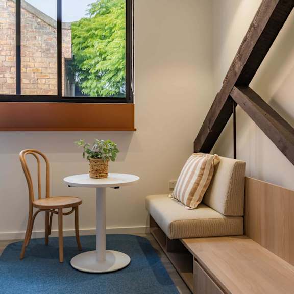a living room with a couch and a table and a window