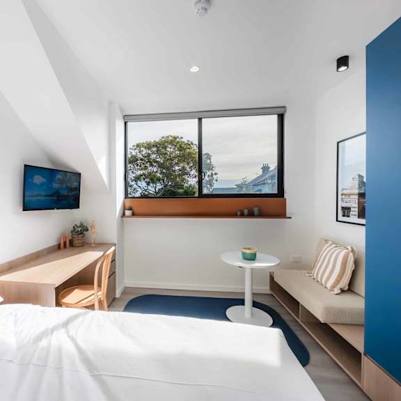 a bedroom with a bed and a window
