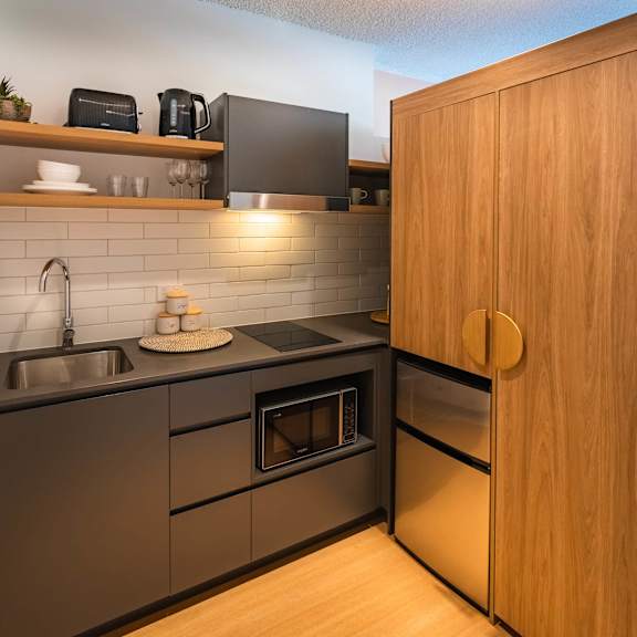 a kitchen with stainless steel appliances and a wood floor