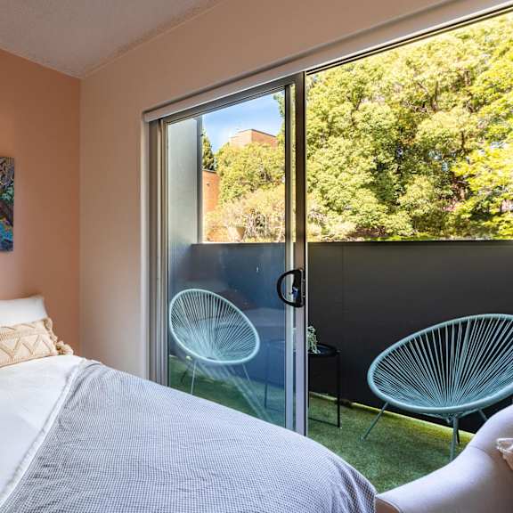a bedroom with a bed and a door to a patio