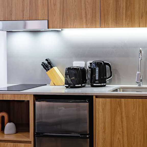 a kitchen with wooden cabinets and a sink