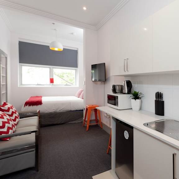 a small kitchen in a room with a bed