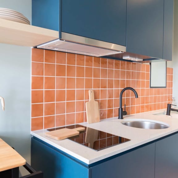 a kitchen with blue cabinets and a sink and a counter top