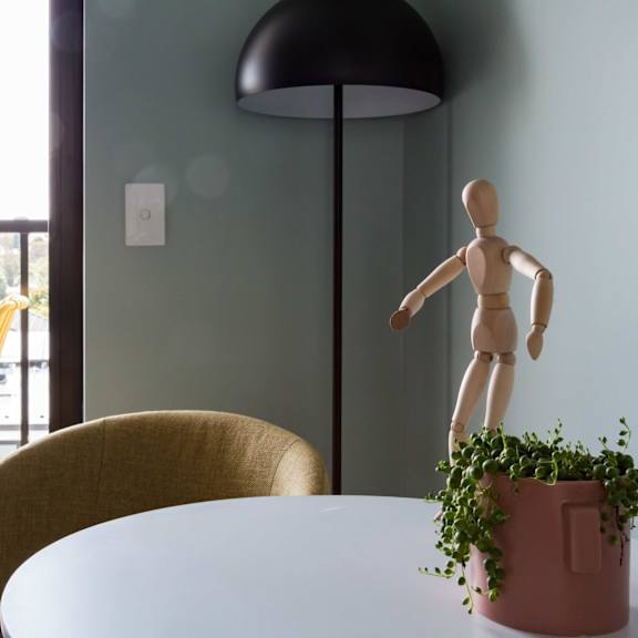 a dining room with a table and chairs and a wooden doll