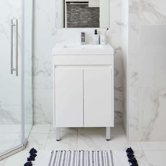 a white bathroom with a sink and a mirror