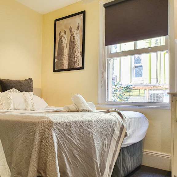 a bedroom with a bed and a window