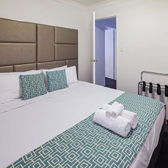 a bed in a hotel room with a towel on it