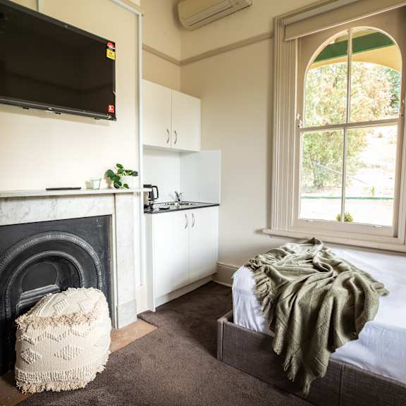 a bedroom with a fireplace and a bed and a television