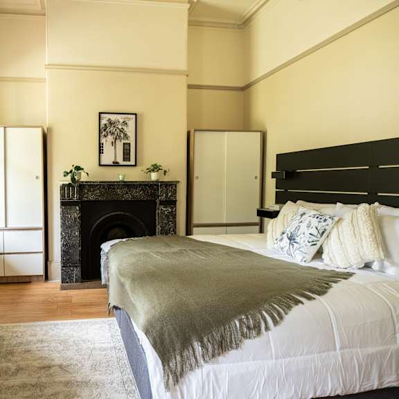 a bedroom with a bed and a fireplace