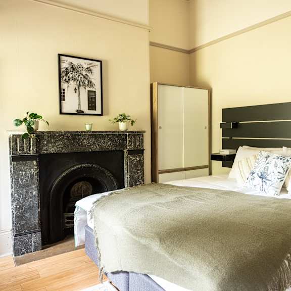 a bedroom with a bed and a fireplace