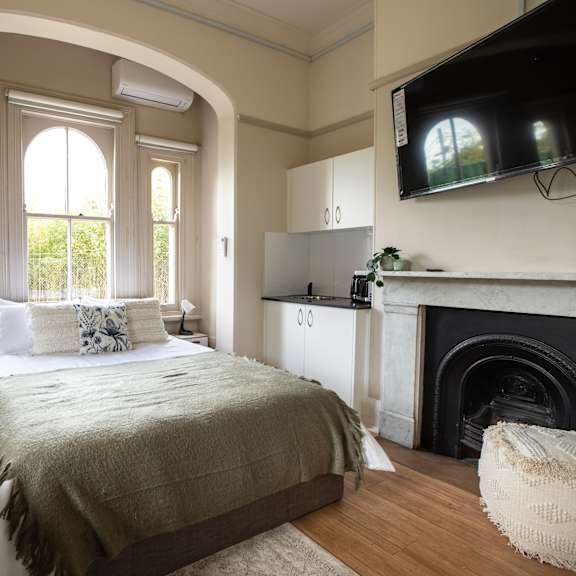 a bedroom with a bed and a fireplace