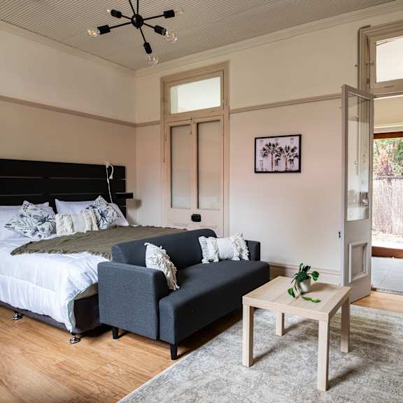 a bedroom with a bed and a couch and a coffee table