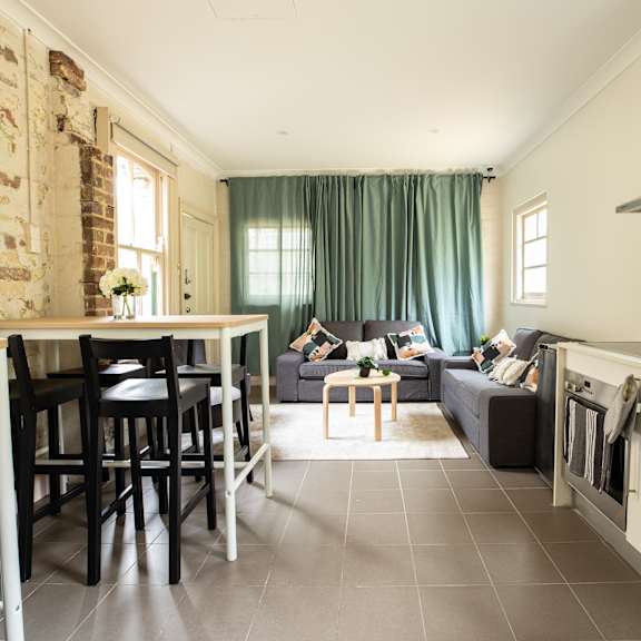 a living room with a kitchen and a couch and a table