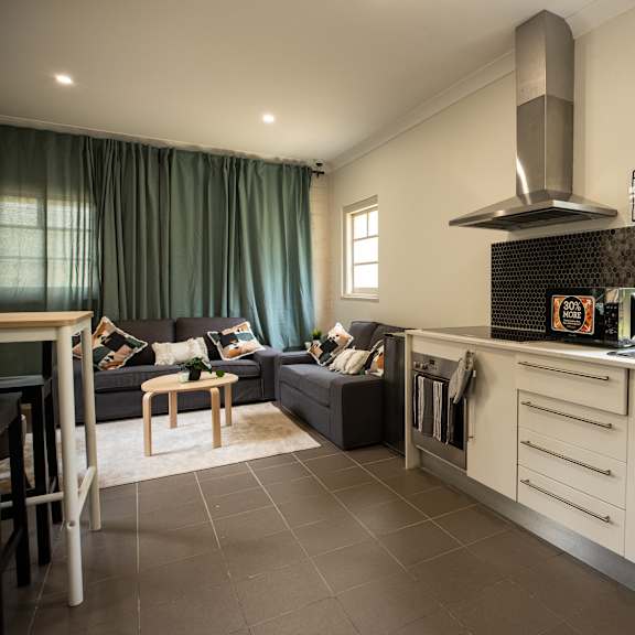 a living room with a kitchen and a couch and a table