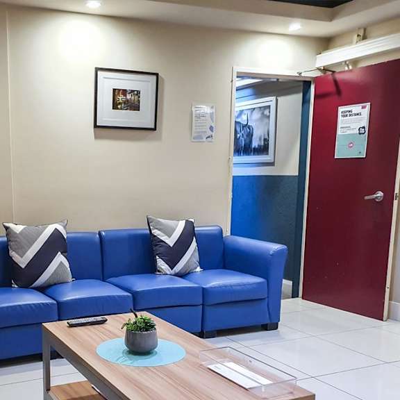 a living room with blue couches and a wooden table