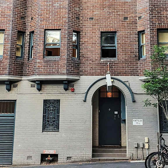 two bikes parked in front of a brick building