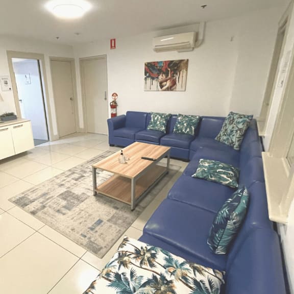 a living room with a blue couch and a tv