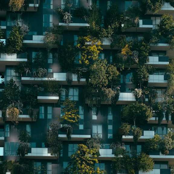 an image of a tall building with trees growing out of it