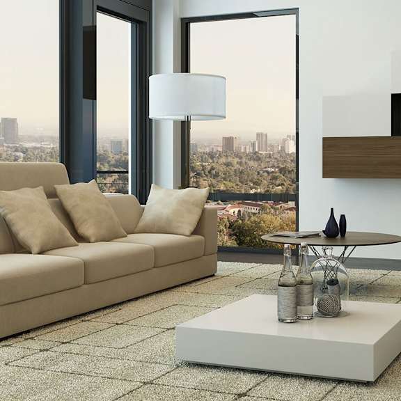 a living room filled with furniture and a large window