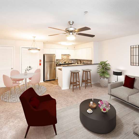 a living room with a red chair and a grey couch.