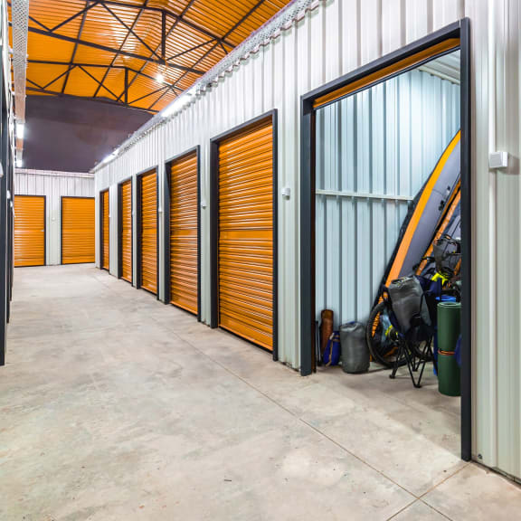 a row of yellow storage doors in a building