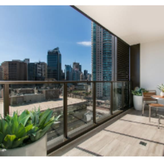 alt -  beautiful view from balcony with coffee table and chair decorated with a planter
