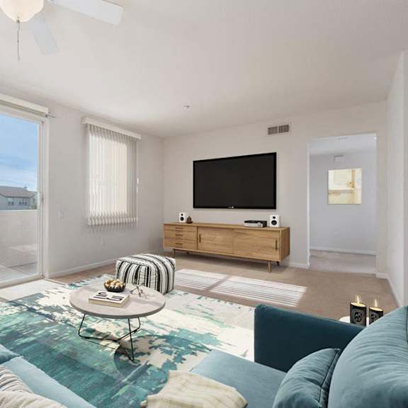 a living room with a blue couch and a television.