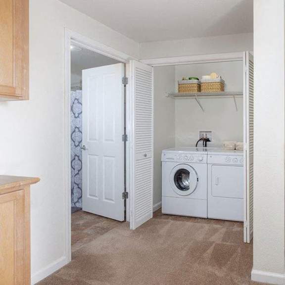 a laundry room with a washer and dryer is shown.