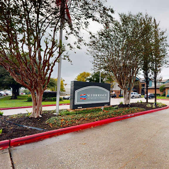 the image shows a sign that says "lutheran" in front of a building.