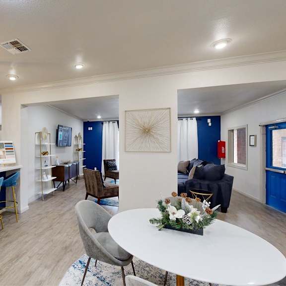 a modern kitchen with blue bar stools and a white island.