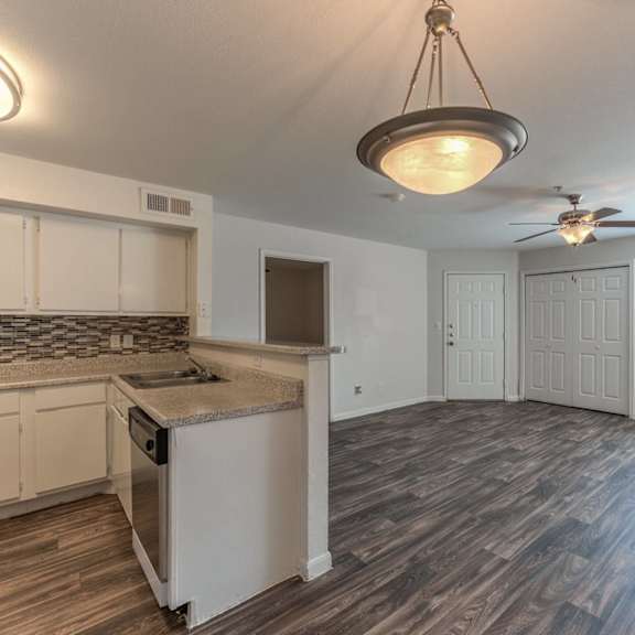 a kitchen with a counter and a fan.