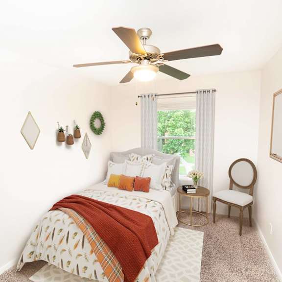 a bedroom with a bed, chair, and a window.