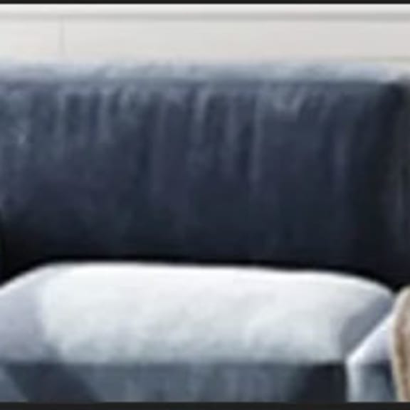 a blue chair sitting next to a white wall
