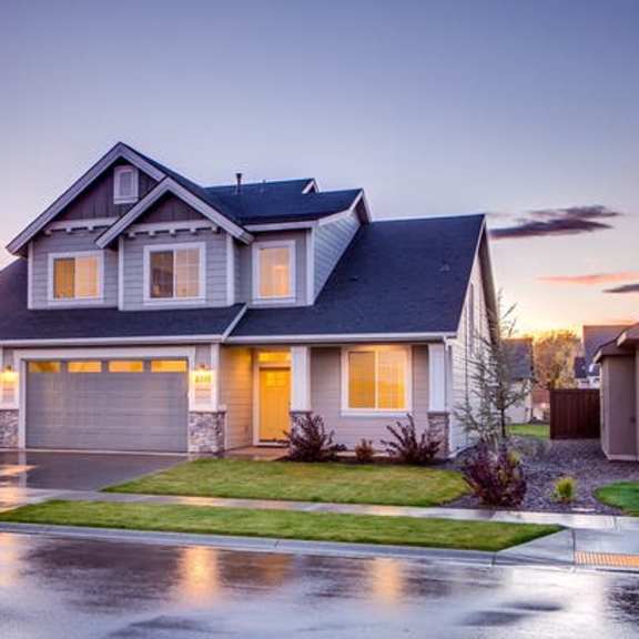 a house with two garages and a driveway