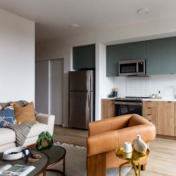 a modern kitchen with a refrigerator, oven, and microwave.