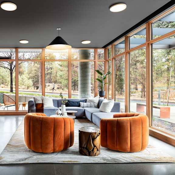 a living room with orange walls and furniture.