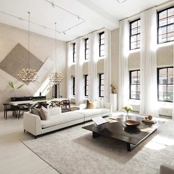 a large living room with a white couch and a table