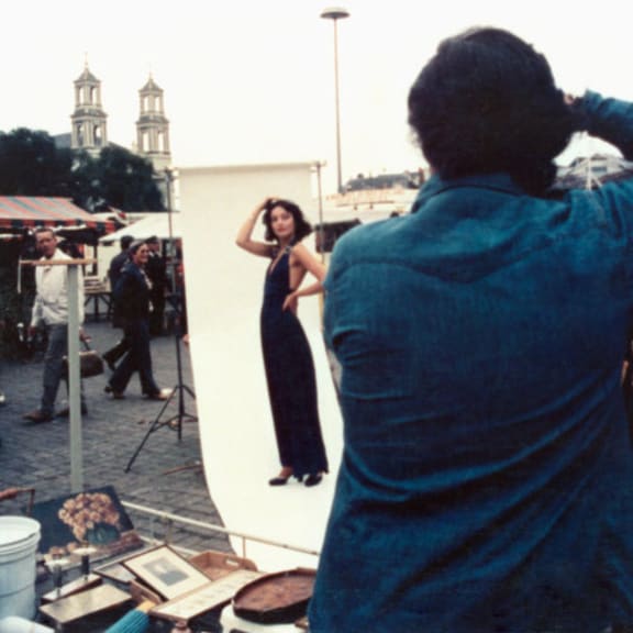 a man taking a picture of a woman in front of a mirror
